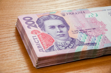 200 hryvnia on a wooden table. Close-up.