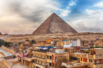 Obraz na płótnie Canvas The Pyramid of Cheops and Giza town nearby, Cairo, Egypt