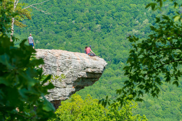 Tourist visitors couple taking pictures at Whitaker Point rock cliff hiking trail, landscape view, Ozark mountains, nwa northwest arkansas
