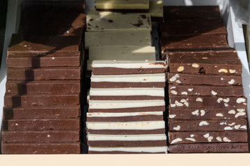 Home made white and brown chocolate pieces displayed for sale at a street food market