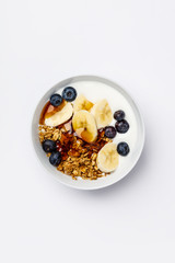 Oat granola with fresh blueberries, banana, yogurt and maple syrup