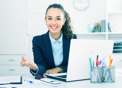 Glad woman working at laptop