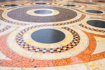 Fototapeta na wymiar mosaic tile folded from marble. wet after rain