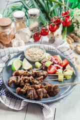 Traditional pork satay with peanut sauce and vegetables