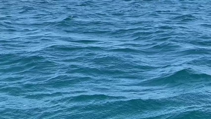 Fast moving blue ocean sea water background 