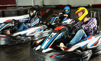 Man and women competing on racing cars © JackF