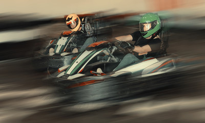 People driving go-kart cars