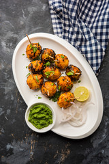 Tandoori aloo are roasted potatoes with Indian spices. It's a party appetiser served with green chutney. selective focus