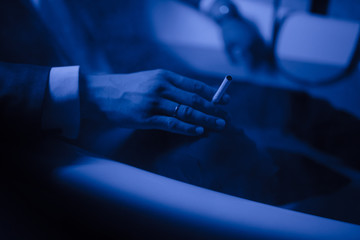 A man in a suit lies in a bath of water.