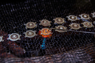 Attacking gold on a silver jewelry. Close up