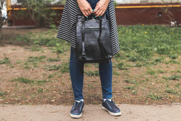 Woman with fashionable backpack on the street.