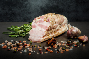 half of salted meat lard with pink salt, spices, garlic, and rosemary