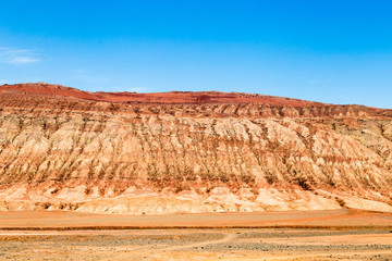 Flaming mountains, Turpan, Xinjiang, China: these intense red arid mountains similar to scorching...
