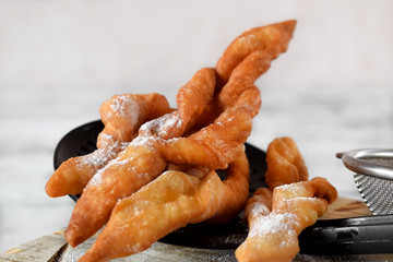 Homemade golden khvorost cookies on skimmer