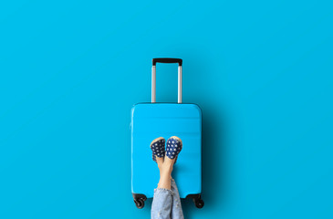 Blue suitcase on the blue background