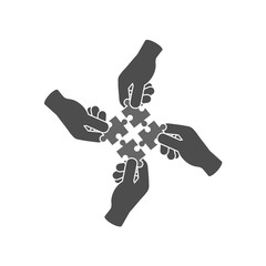 Teamwork and cooperation icon or logo concept. Hands holding and putting puzzle pieces together