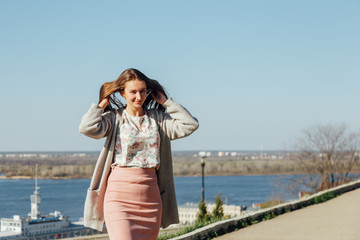 Girl shows tongue with an open mouth and raises the hair.