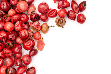 Lot of whole peruvian pink pepper copyspace flatlay isolated on white background