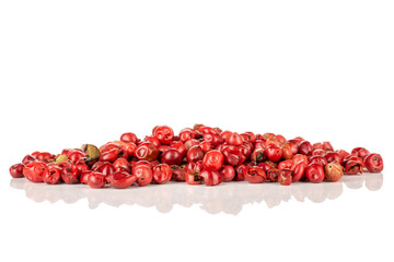 Lot of whole peruvian pink pepper stack isolated on white background