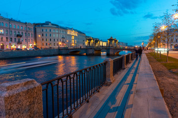 Fototapeta na wymiar Lomonosov Bridge across the Fontanka River in Saint Petersburg, Russia. Historical towered movable bridge, build in 18th century