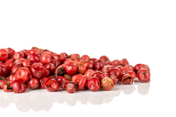 Lot of whole peruvian pink pepper macro isolated on white background