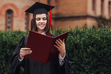 Graduation Concept. Graduated students on graduation day with diploma on hands!