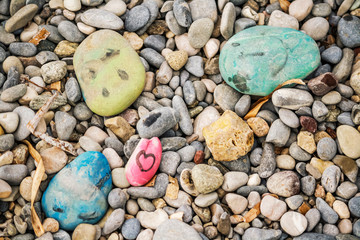 Stones painted by children on a beach