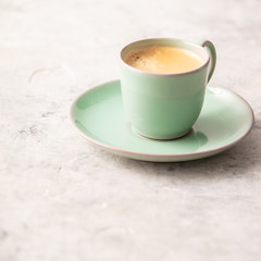 A cup of coffee on light grey background