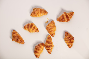 Delicious fresh mini croissants on white background