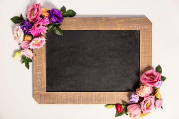 Summer flowers frame composition made with chalkboard and variou