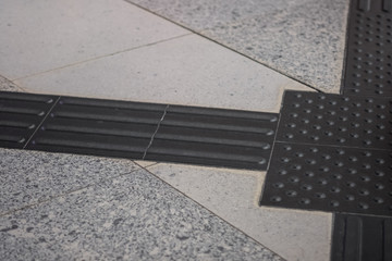 Tactile paving for blind handicap on tiles pathway, walkway for blindness people with train station...