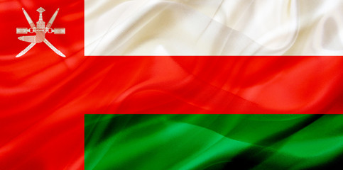Obraz premium Oman country flag on silk or silky waving texture