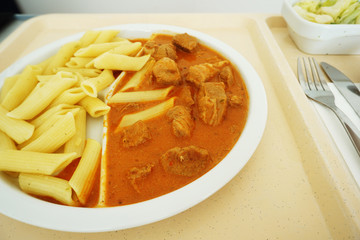 Goulash with sauce and noodles served for dinner on the tray