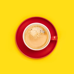 Red cup of coffee on yellow background