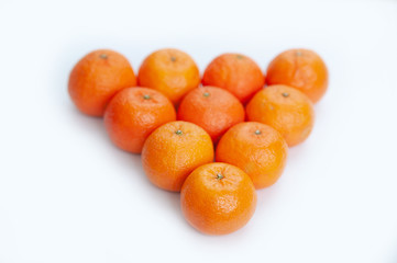 a pyramid of fresh tangerines isolated on white background