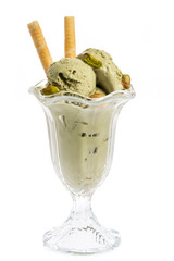 pistachio ice cream sundae with waffles and pistachio kernel isolated on white background - front...