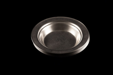 Simple plates of stainless steel on a dark black background