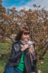 Young cute woman on a sakura background. Spring time.