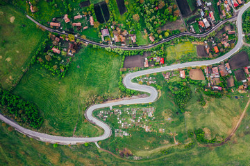 Curvy road from a drone view and agriculture fields