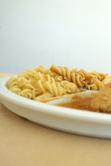 Chicken breast served with noodles and gravy on a tray