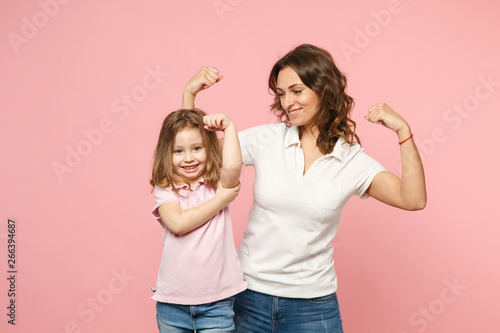 Woman in light clothes have fun with cute child baby girl. Mother, little kid daughter isolated on pastel pink wall background, studio portrait. Mother's Day, love family, parenthood childhood concept
