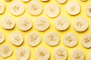 Creative summer pattern made of bananas slice on pastel yellow background. Fruit minimal concept. Flat lay.