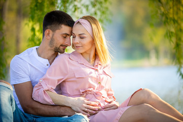 Happy couple expecting baby, pregnant woman with husband, young family and new life concept