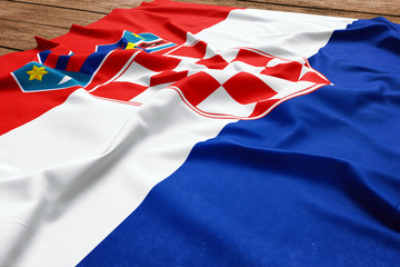 Flag of Croatia on a wooden desk background. Silk Croatian flag top view.