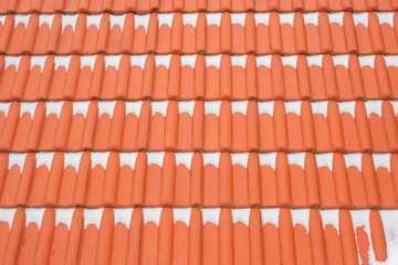 Red roof tiles in winter