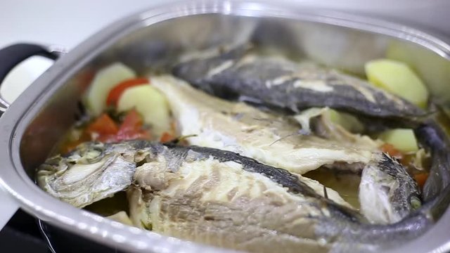 fresh sea bream cooked into the casserole with fresh vegetables and olive oil