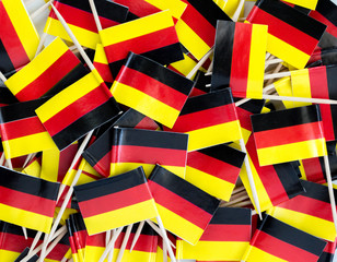 background wallpaper-a jumble of red, gold and black German flags on cupcake toothpicks