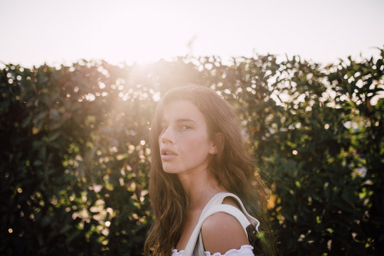 Portrait of beautiful woman enjoying a day in the city against the sunset