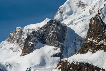 Mountain peaks with glaciers on the slope of Ullu-Tau Chana in the Kabardino-Balkarian Republic, Caucasus, Russia, May 2019