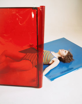 Young woman with translucent red and blue squares